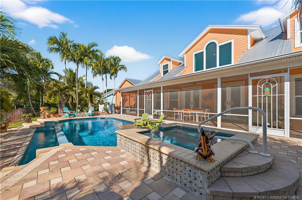 802 Southeast Portage Avenue Port St. Lucie, FL 34984 - Photo 39 of 48 a view of a house with swimming pool and sitting area