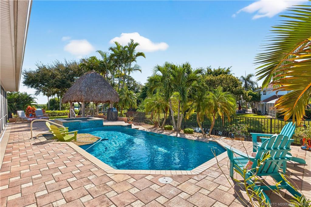 802 Southeast Portage Avenue Port St. Lucie, FL 34984 - Photo 40 of 48 a view of a swimming pool with a patio