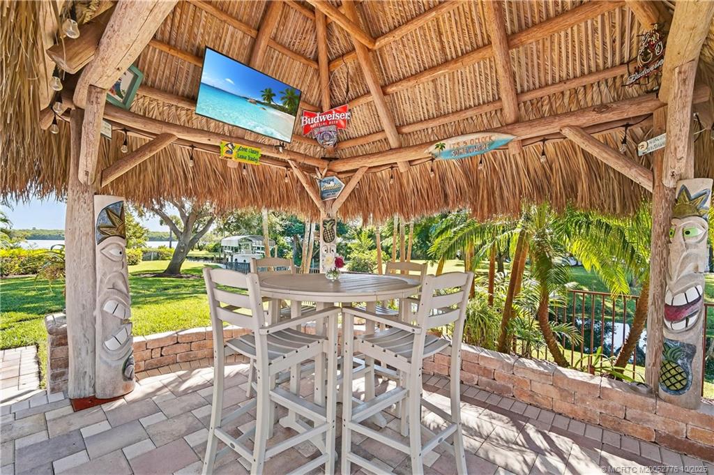 802 Southeast Portage Avenue Port St. Lucie, FL 34984 - Photo 43 of 48 a view of a patio with table and chairs and potted plants