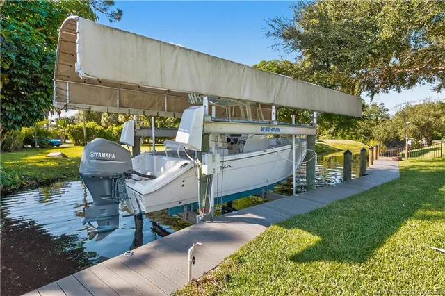 a view of a swimming pool with potted plants