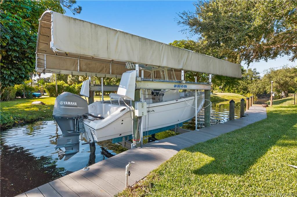 802 Southeast Portage Avenue Port St. Lucie, FL 34984 - Photo 45 of 48 a view of a patio with table and chairs under an umbrella