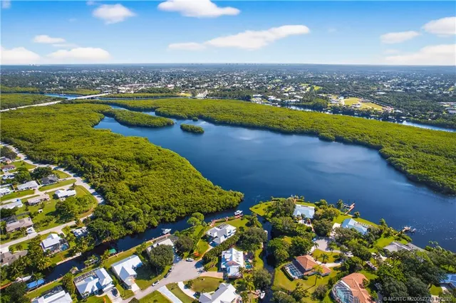 an aerial view of a house with garden space and trees