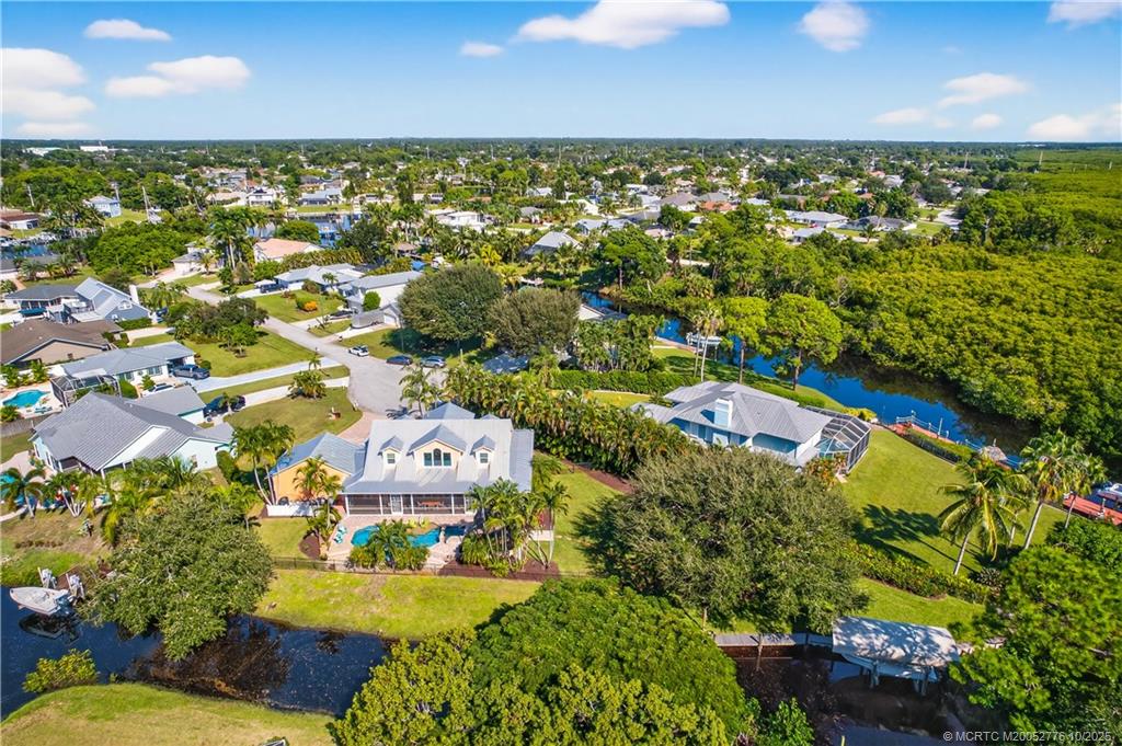 802 Southeast Portage Avenue Port St. Lucie, FL 34984 - Photo 7 of 48 an aerial view of residential houses with outdoor space and trees all around