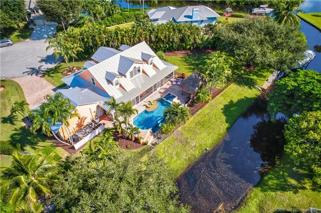 an aerial view of residential house with outdoor space and swimming pool