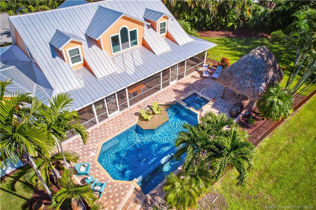 802 Southeast Portage Avenue Port St. Lucie, FL 34984 - Photo 9 of 48 an aerial view of residential house with outdoor space and swimming pool