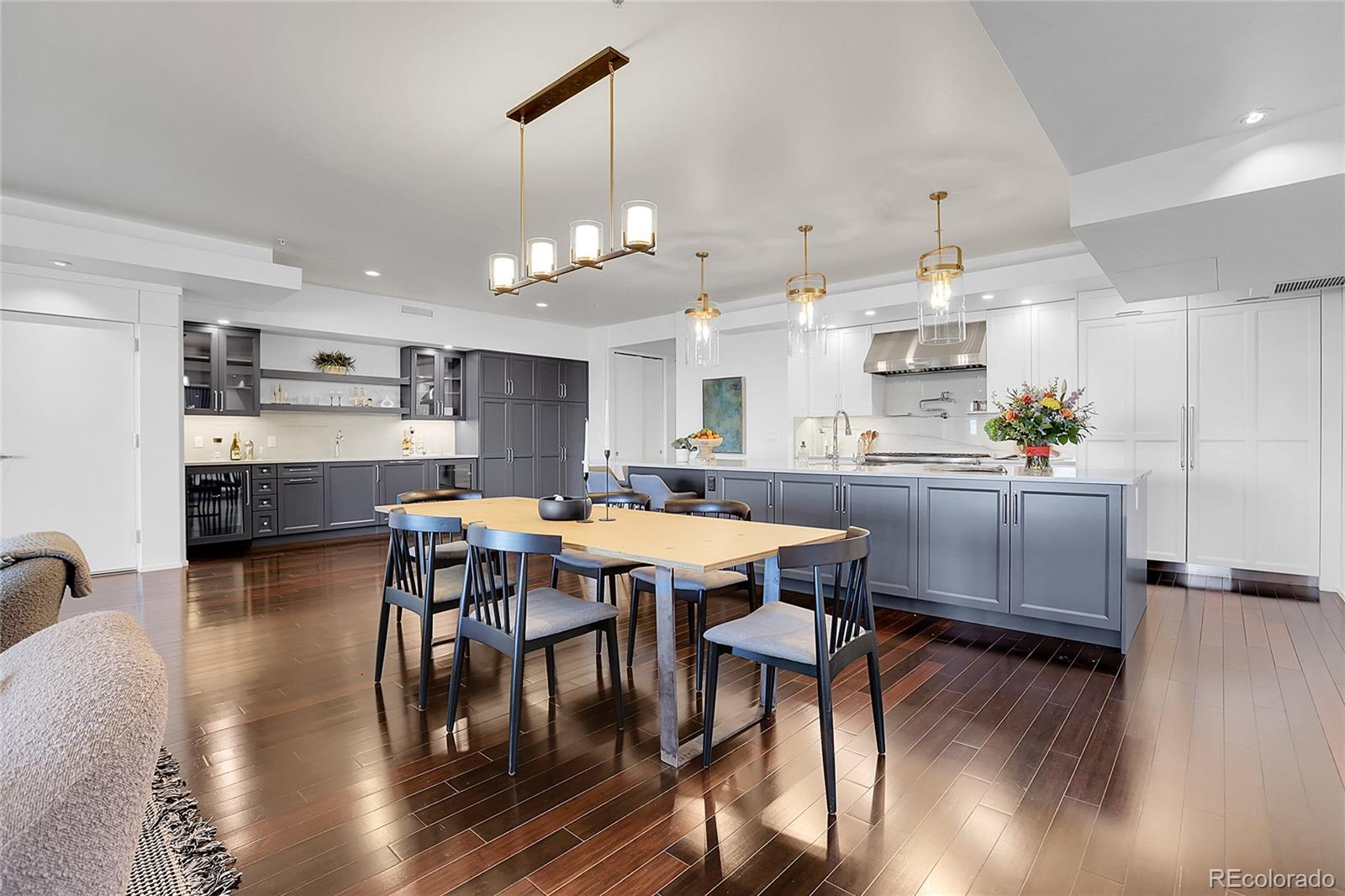 3131 Zuni Street, Unit 302 Denver, CO 80211 - Photo 1 of 36 a kitchen with stainless steel appliances kitchen island granite countertop a table chairs and a refrigerator