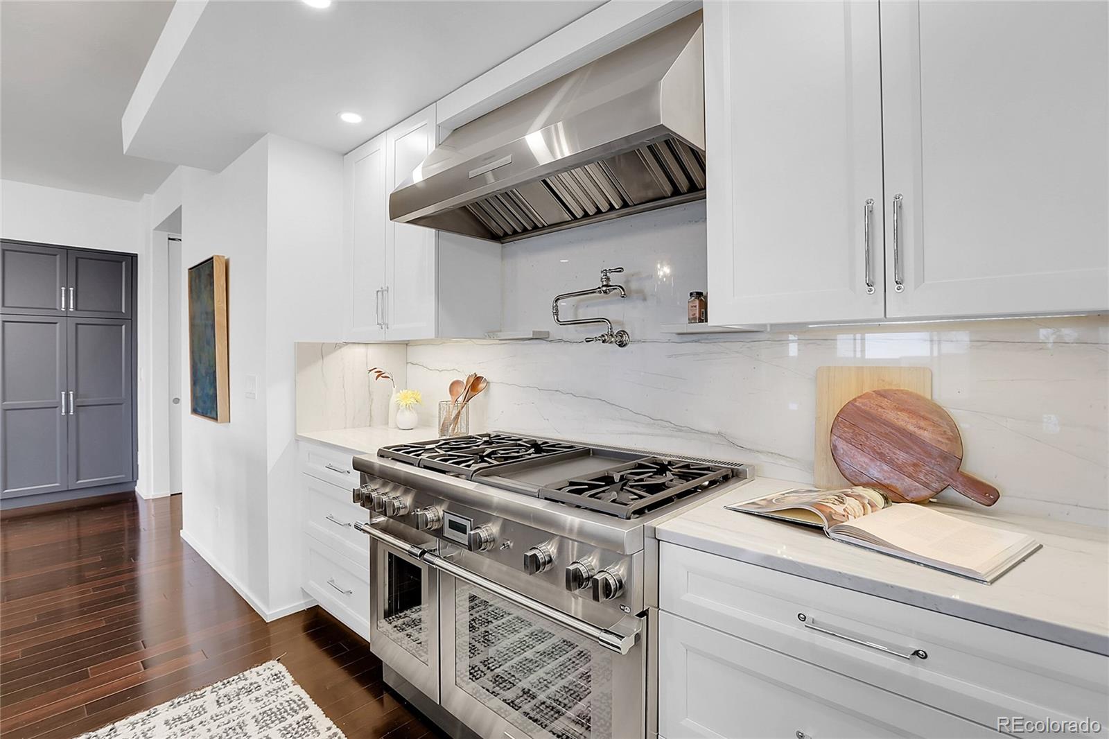 3131 Zuni Street, Unit 302 Denver, CO 80211 - Photo 13 of 36 a kitchen with stainless steel appliances granite countertop a stove and a white cabinets