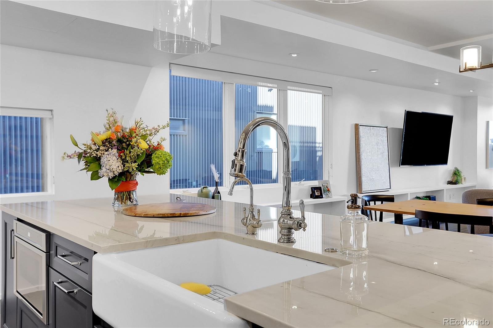 3131 Zuni Street, Unit 302 Denver, CO 80211 - Photo 15 of 36 a kitchen with a faucet a sink and a flat screen tv