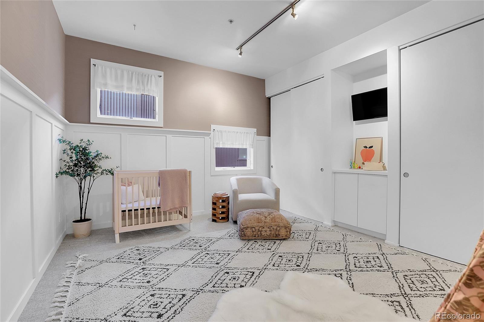 3131 Zuni Street, Unit 302 Denver, CO 80211 - Photo 22 of 36 a bedroom with a bed and a couch
