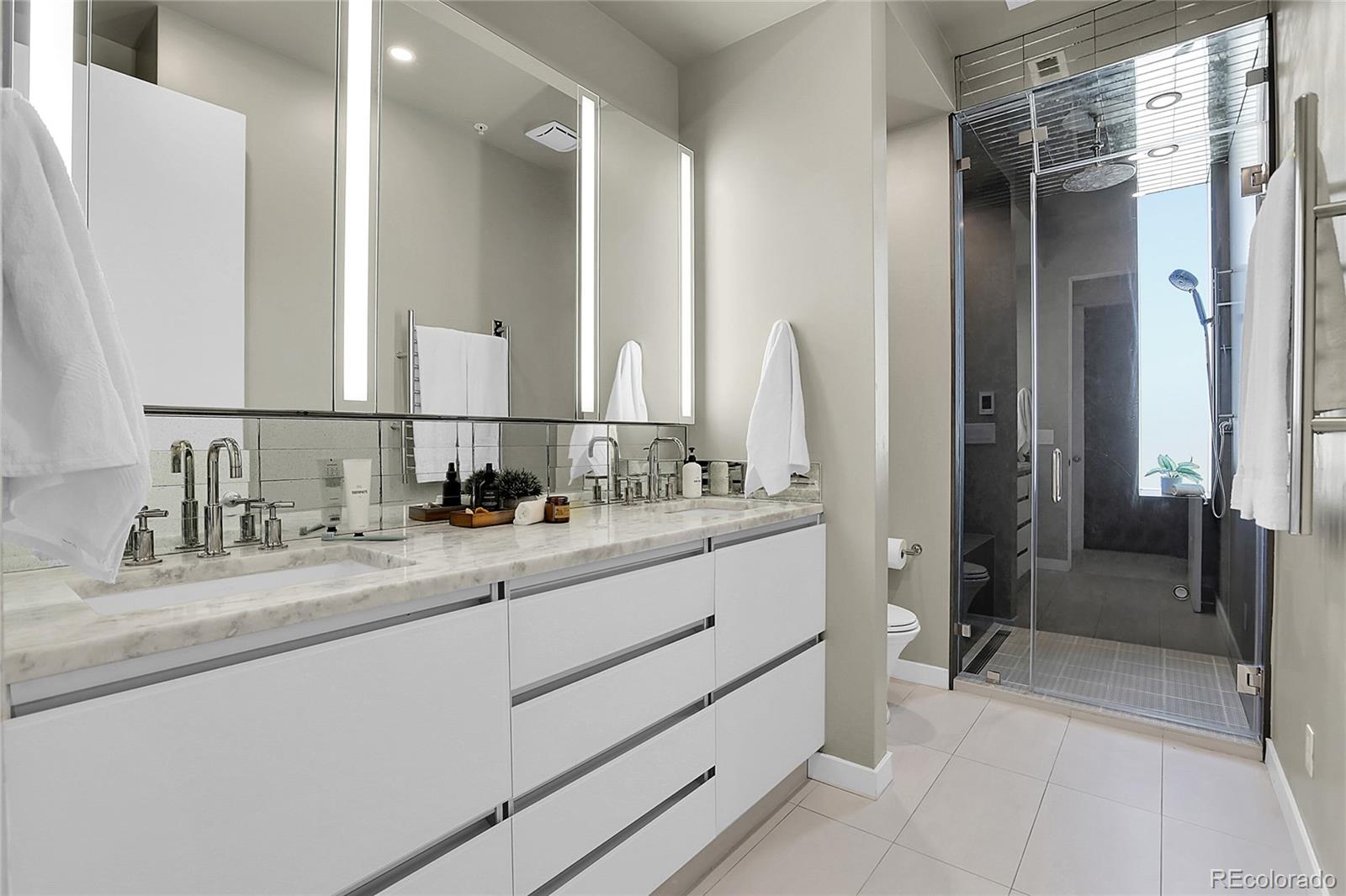 3131 Zuni Street, Unit 302 Denver, CO 80211 - Photo 27 of 36 a bathroom with double sink and two mirror