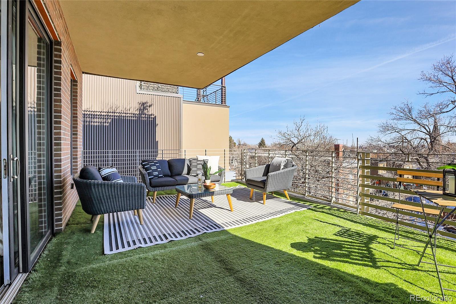 3131 Zuni Street, Unit 302 Denver, CO 80211 - Photo 34 of 36 a view of a patio with couches chairs and a yard