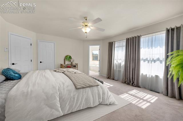 7425 Tobin Road Colorado Springs, CO 80908 - Photo 6 of 9 The virtually staged master bedroom features large windows, walk-in closet, plus 5-piece bath.