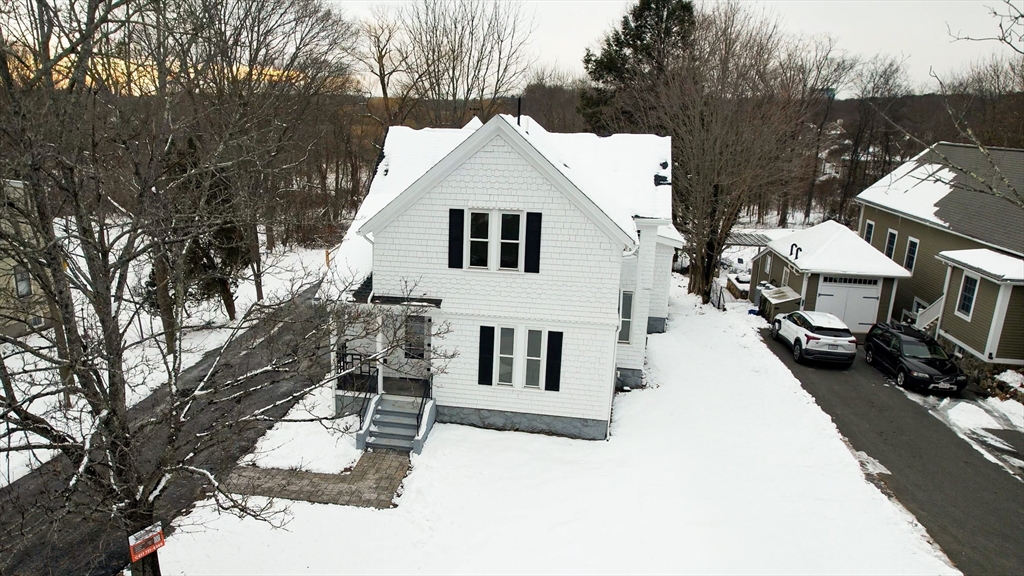 a view of a house with a yard covered in snow