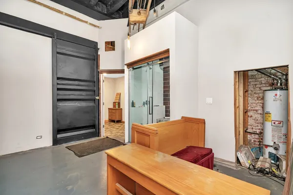 a bedroom with a bed and a flat tv screen on dresser