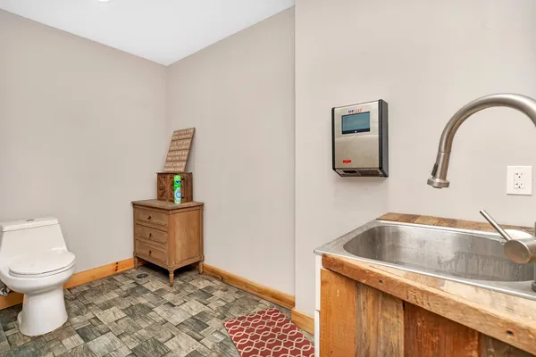 a bathroom with a sink a toilet and mirror