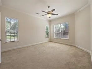 a view of a livingroom with a ceiling fan and window