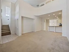 an empty room with white walls and windows