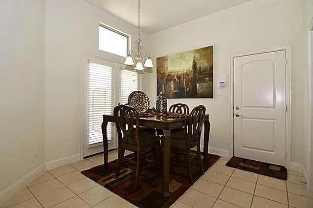 a view of a dining room with furniture and window