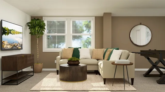 a living room with furniture a window and a potted plant