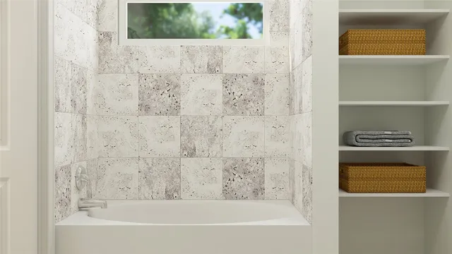 a bathroom with a bathtub and shower