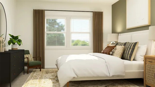 a bed sitting in a bedroom next to a window