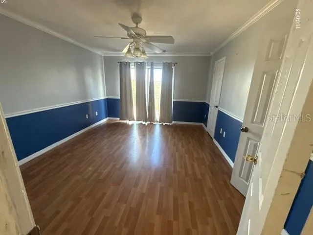 wooden floor in an empty room with a window
