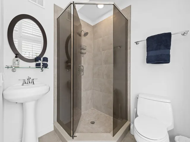 a bathroom with a toilet a sink and a mirror