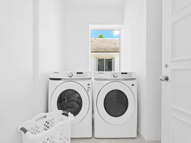 a view of a hallway with washer and dryer