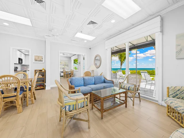 a view of a brick wall with plants and large trees