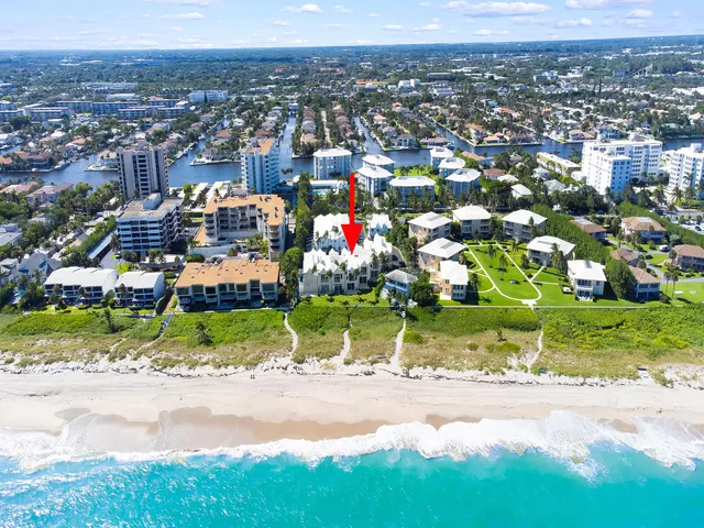 an aerial view of a houses with yard and city view