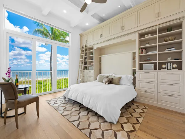 a bedroom with a bed and a large window