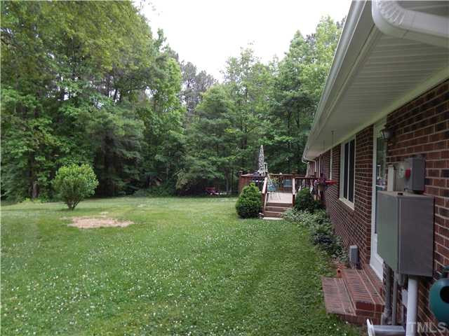 2539 Burton Road Durham, NC 27704 - Photo 5 of 18 a view of backyard with barbeque grill potted plants and large tree