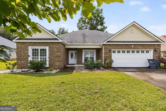 a front view of a house with a yard