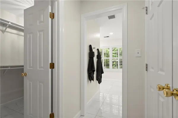 a close view of walk in closet and bathroom