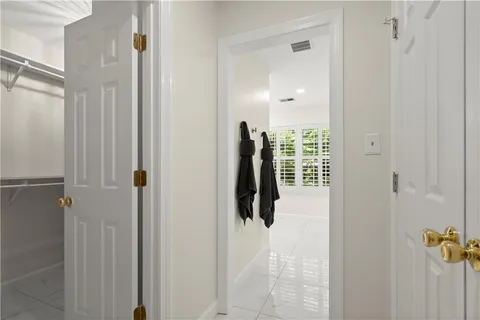 a close view of walk in closet and bathroom