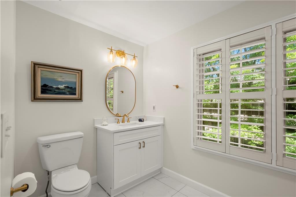 40 Ivy Chase Northeast Atlanta, GA 30342 - Photo 22 of 38 a bathroom with a toilet a sink and a mirror