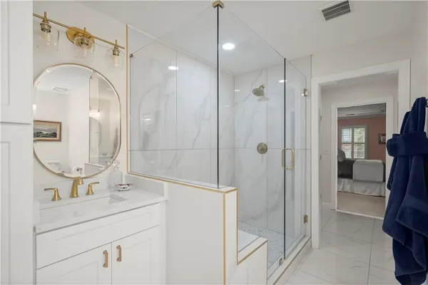 a bathroom with a double vanity sink mirror and shower