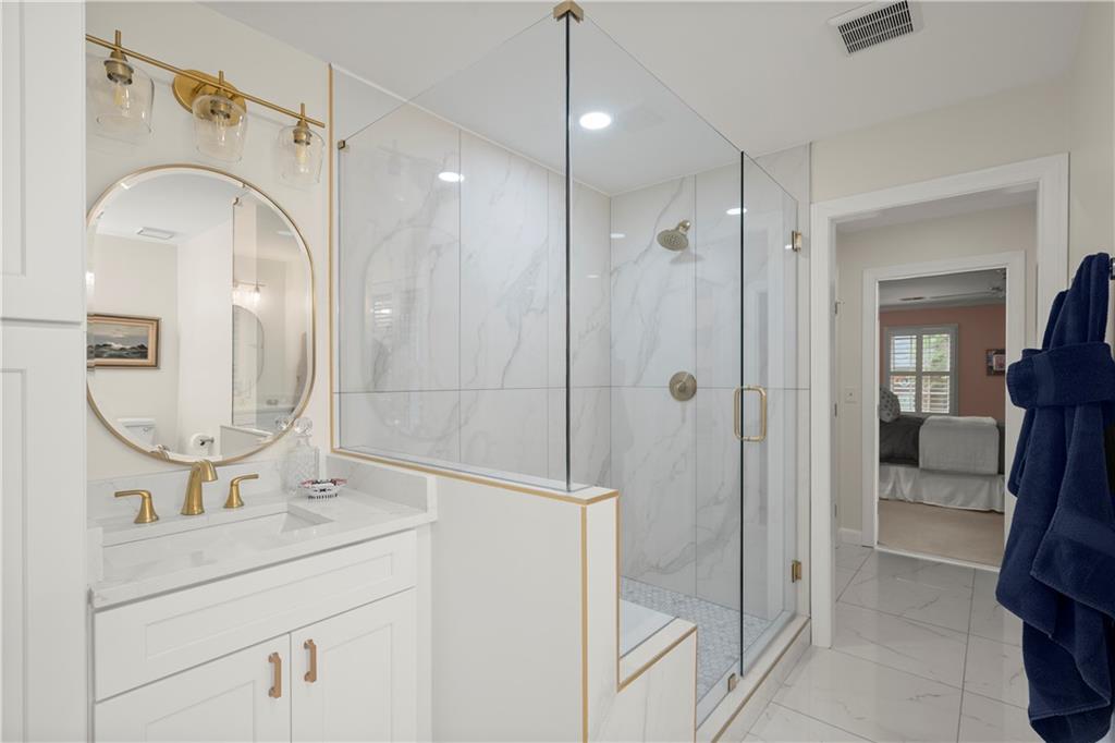 40 Ivy Chase Northeast Atlanta, GA 30342 - Photo 24 of 39 a bathroom with a double vanity sink mirror and shower