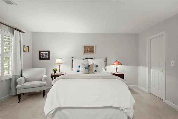 a bedroom with a bed and a couch