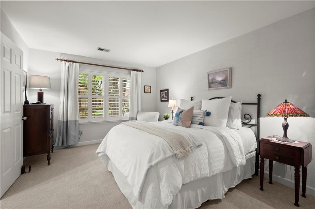 40 Ivy Chase Northeast Atlanta, GA 30342 - Photo 25 of 38 a spacious bedroom with a bed and a large window