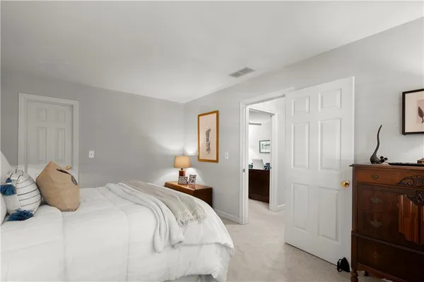 a bedroom with a bed and a dresser