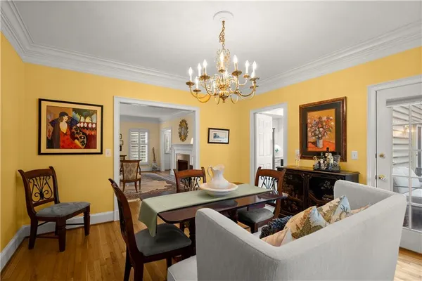 a view of a dining room with furniture and chandelier