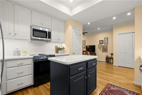 a kitchen with a sink stove and microwave