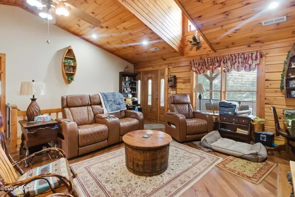 a living room with lots of furniture and a large window