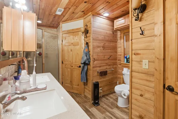 a bathroom with a toilet and a shower curtain