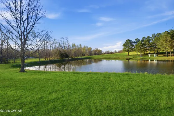 a view of a lake with houses in the back