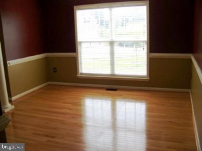 4 Gallery Road Stafford, VA 22554 - Photo 2 of 21 a view of an empty room with wooden floor and a window
