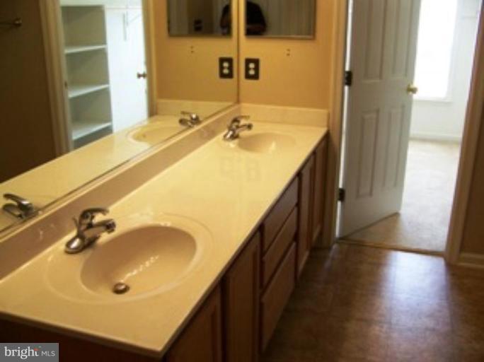 4 Gallery Road Stafford, VA 22554 - Photo 11 of 21 a bathroom with a sink and a large mirror