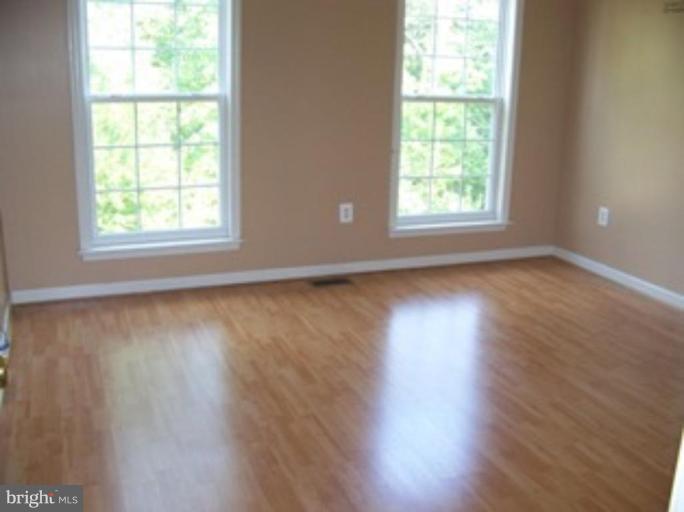 4 Gallery Road Stafford, VA 22554 - Photo 18 of 21 a view of an empty room with wooden floor and a window