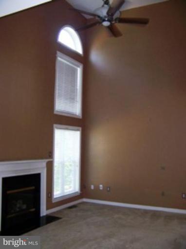 4 Gallery Road Stafford, VA 22554 - Photo 4 of 21 an empty room with a fireplace and windows